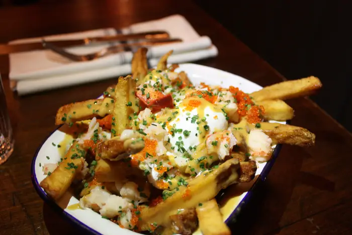 Lobster Bisque Fries with tobiko and a poached egg<br>